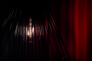 The Black Lodge: abstract light bulb against red curtains